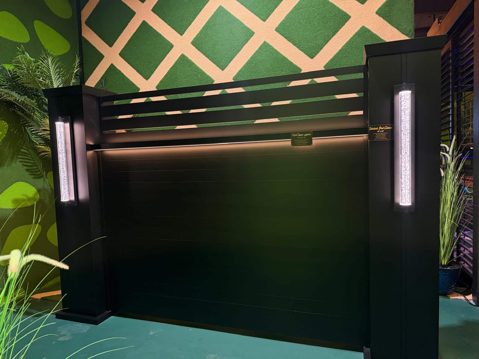 Black horizontal aluminum fence with lighted posts at the Lumina showroom