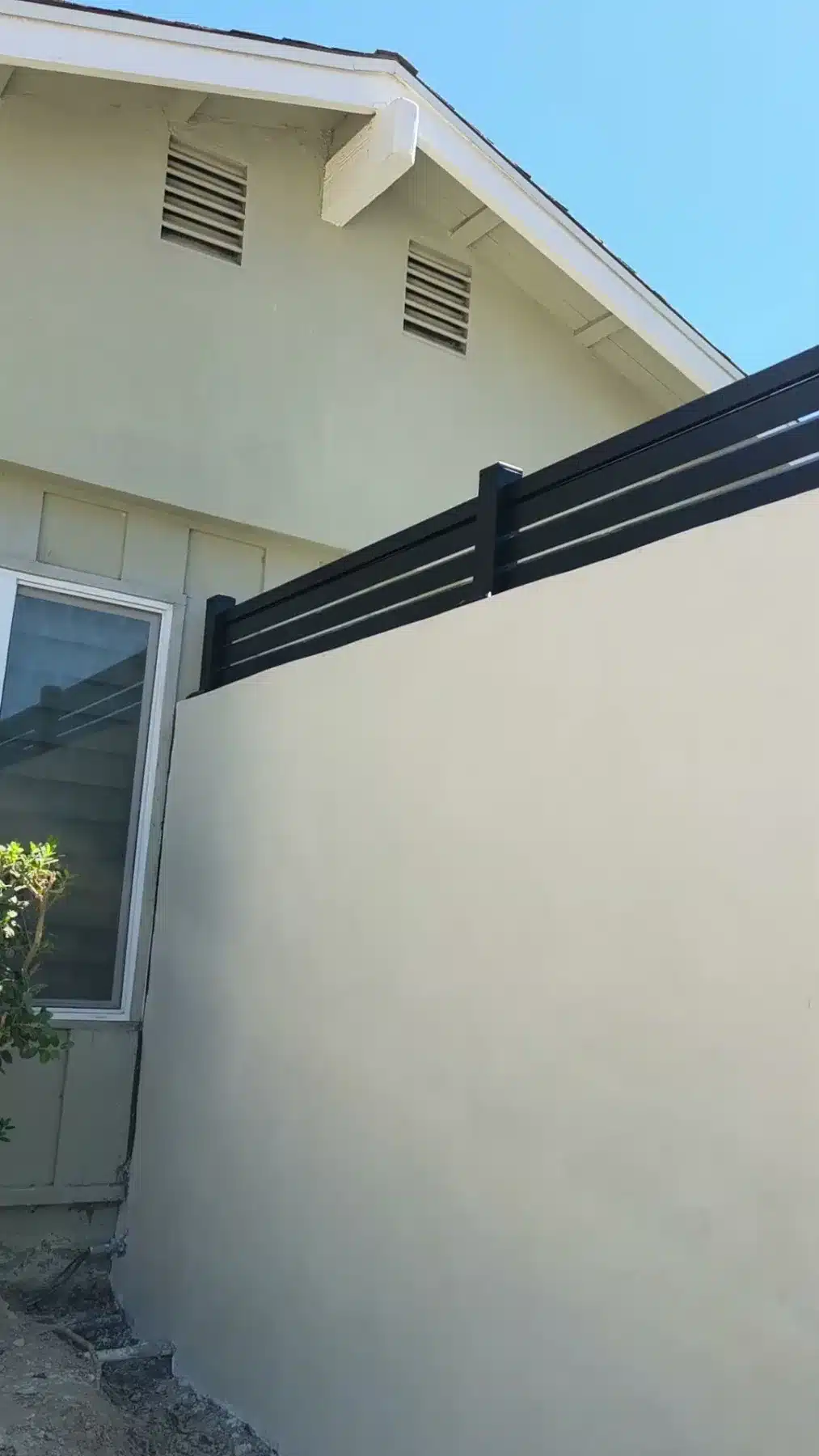 Black aluminum fence above a stucco wall in Calabasas