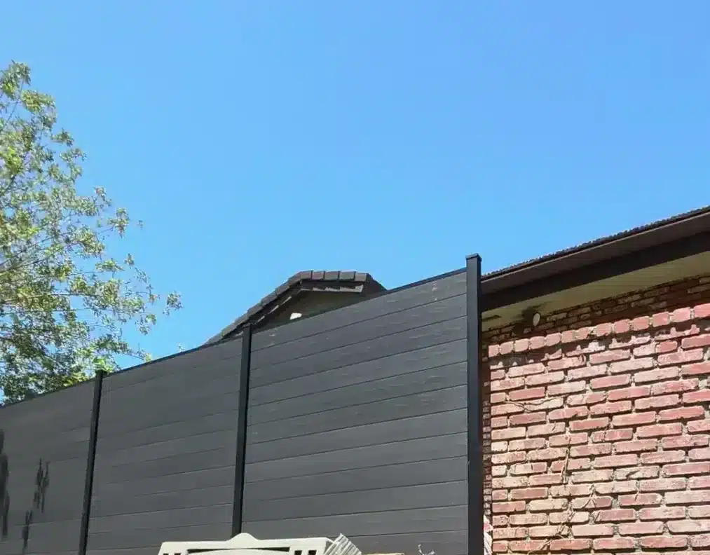 Dark gray WPC composite privacy fence along a property line in Encino, CA