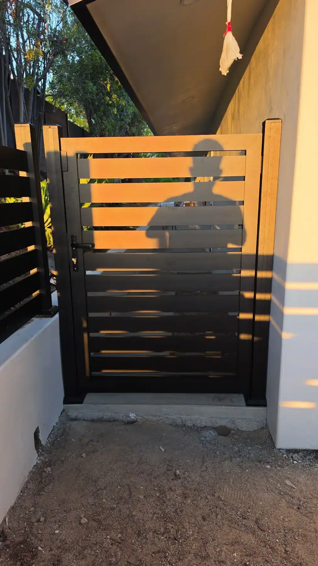 Close-up of a Ridgeline horizontal slat aluminum gate at an Encino home