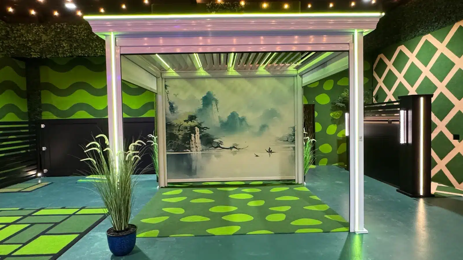 Pebble-pattern LuxTurf artificial turf leading to a glass sunroom with sliding doors at the Lumina showroom