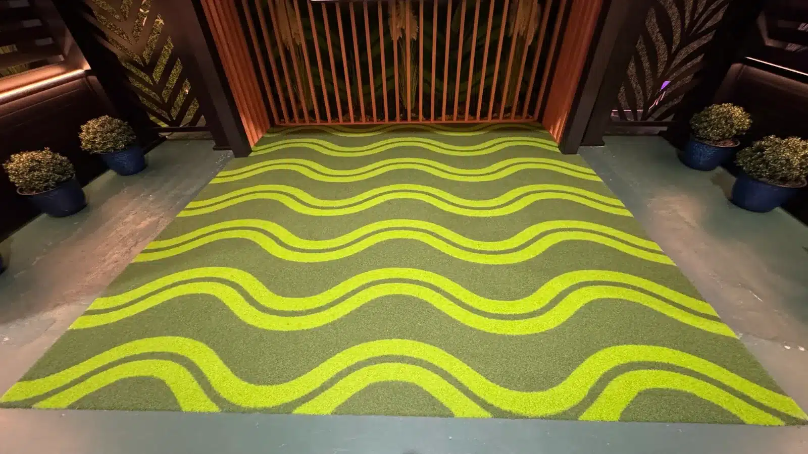 Close-up of wave-pattern LuxTurf artificial grass in two shades of green