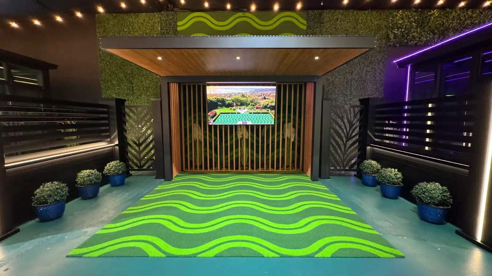 Wave-pattern LuxTurf artificial turf under a louvered pergola at the Lumina showroom in Panorama City